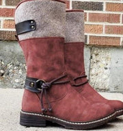 Stylish red suede snow boots with felt upper, leather straps, and a rugged sole for winter wear.
